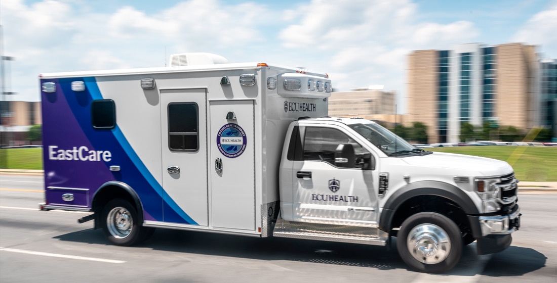 An ECU Health EastCare ambulance drives down the road.