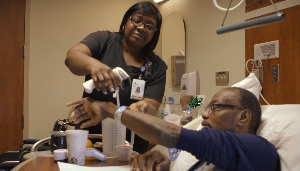 Nurse Latasha Roberson works with a patient.