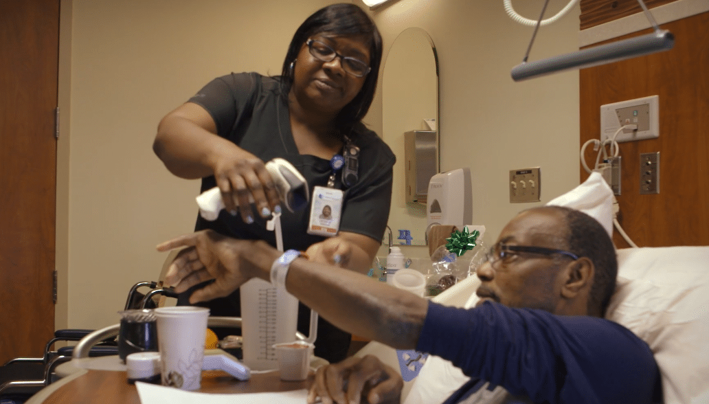 Roberson Story Nurse Latasha Roberson works with a patient.