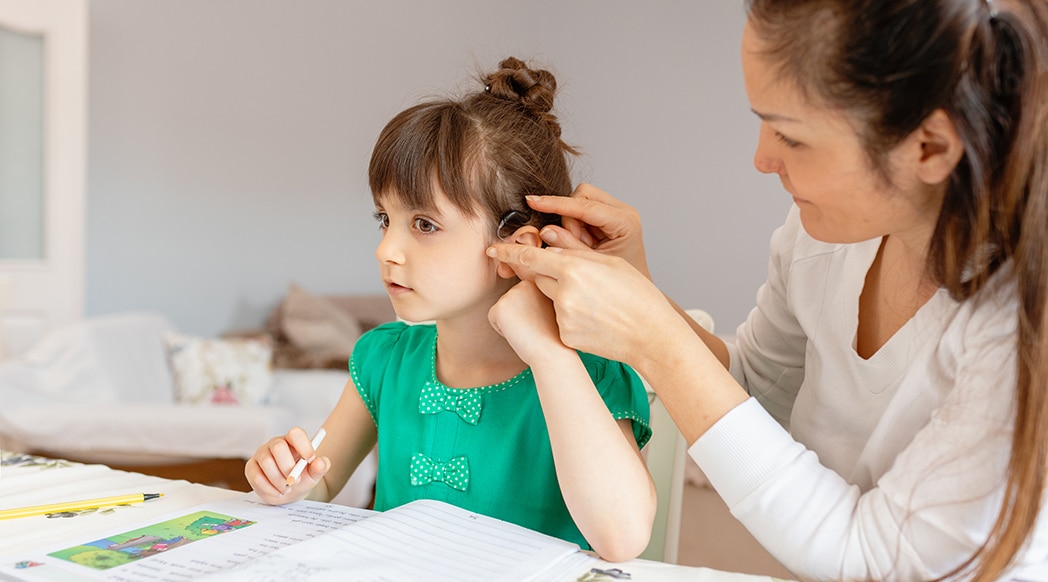 Mother helping daughters with homework