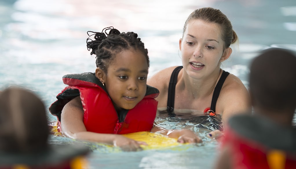 Swim Instructor Working with a Little Girl