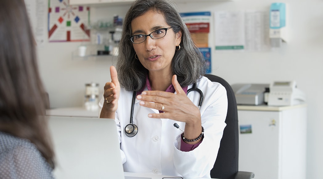 Mixed Race doctor talking to patient Gynecologist talking to patient