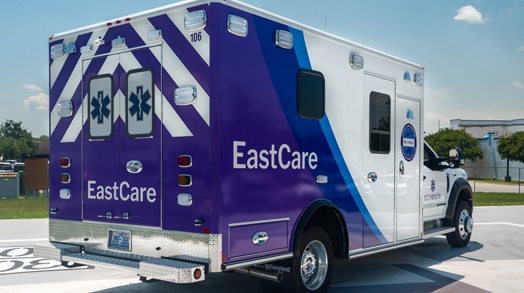 An ECU Health EastCare ambulance sits parked.