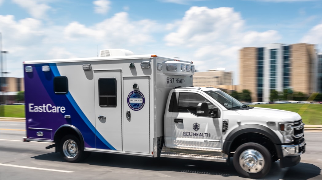 An ECU Health EastCare ambulance drives down the road.