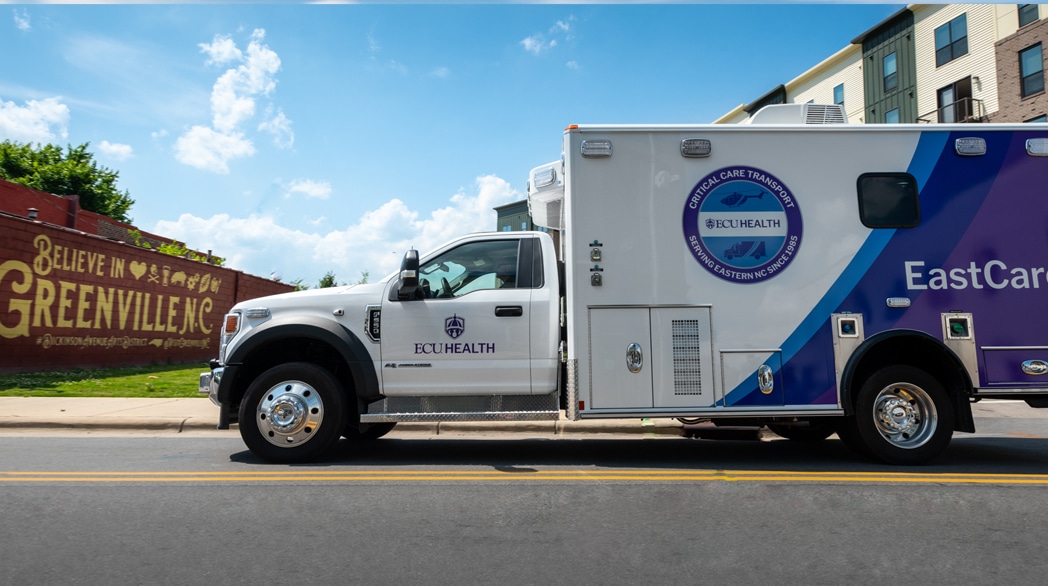 An ECU Health EastCare ambulance drives down the road.