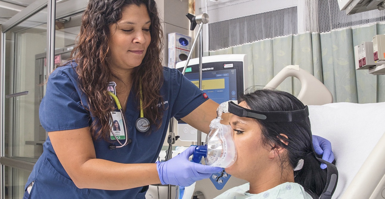 A health care provider examines a patient.