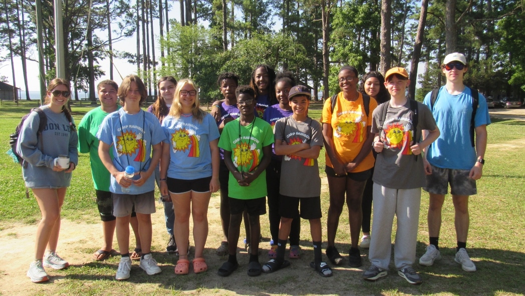 Young people gather for a group photo at a camp.