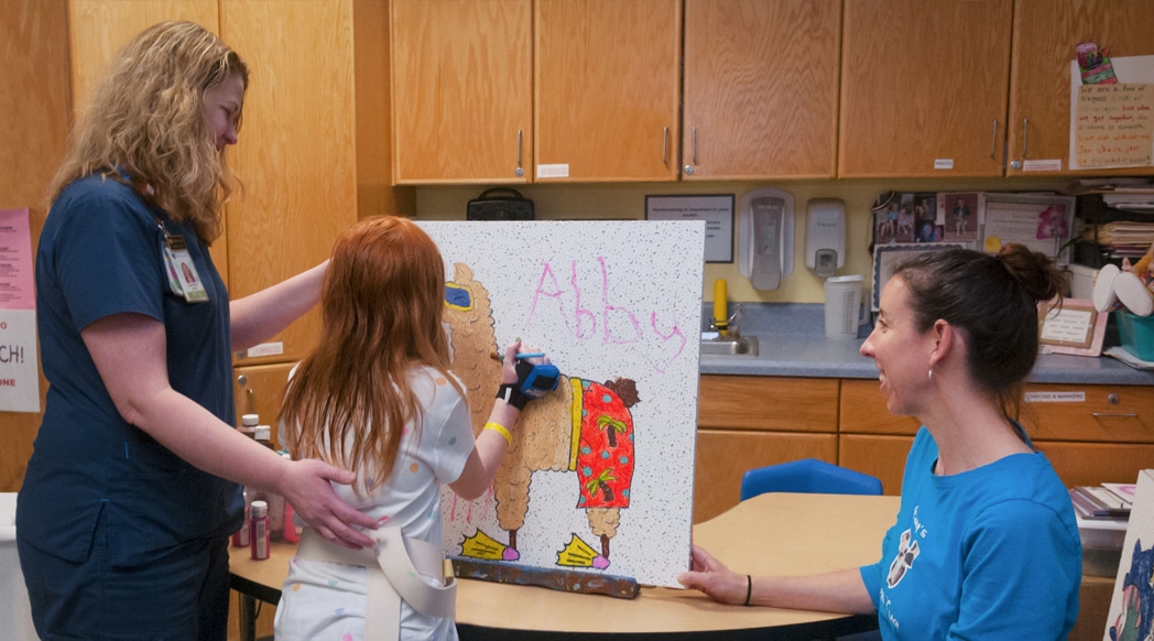 Art activities such as decorating a commemorative ceiling tile to be placed in the rehab space prior to discharge home are one of the ways we encourage therapy and fun at the same time.
