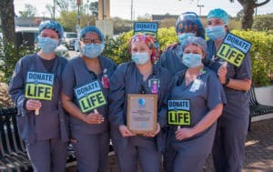 ECU Health Medical Center team members pose with an award during the Pause to Give Life event