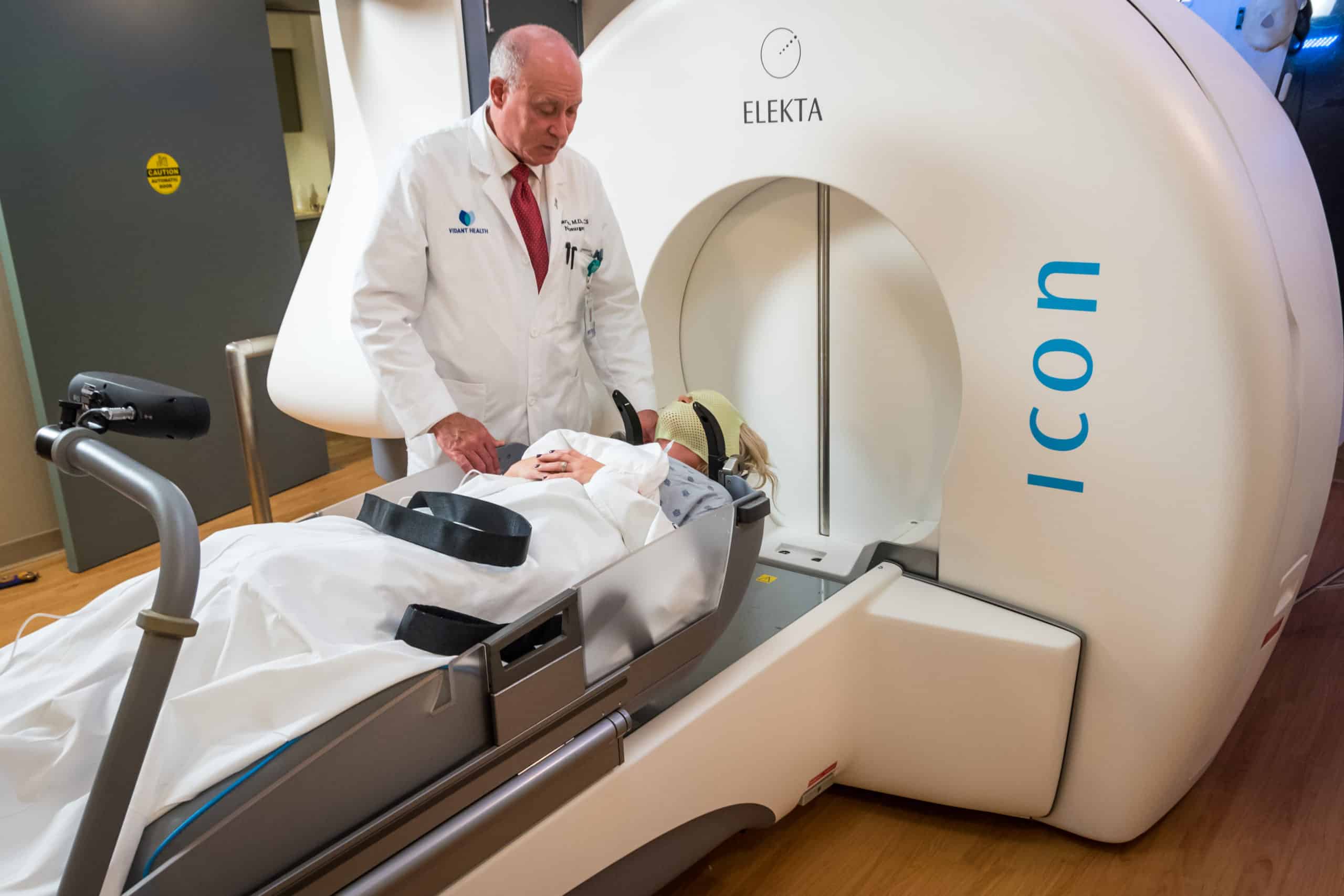 Dr. Lee talks with a patient prior to a round of Gamma Knife radiosurgery.