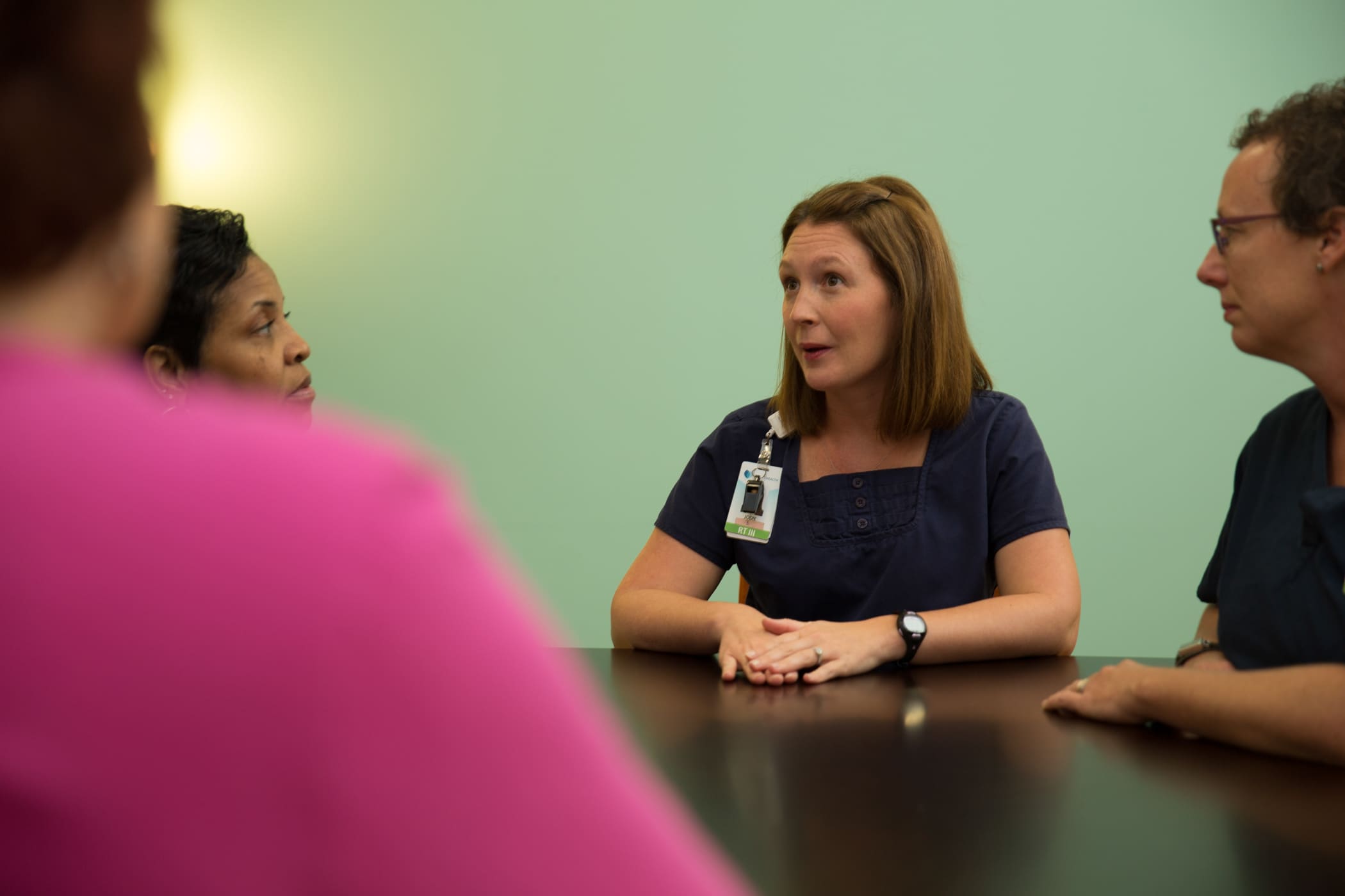 Team members talking around a table