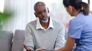A man discusses symptoms with a nurse