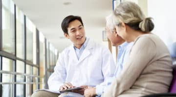 A doctor talks with two patients