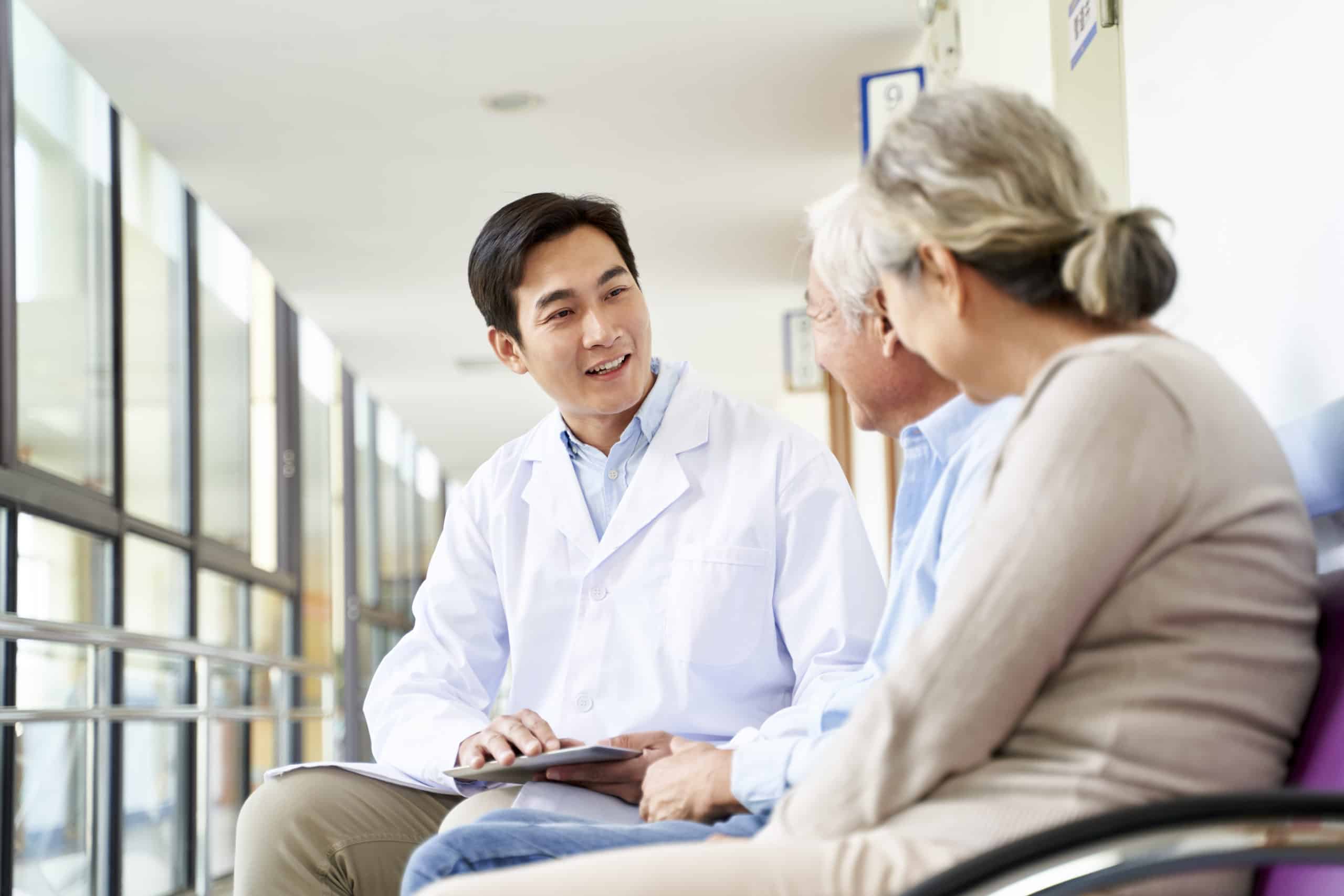 A doctor talks with two patients