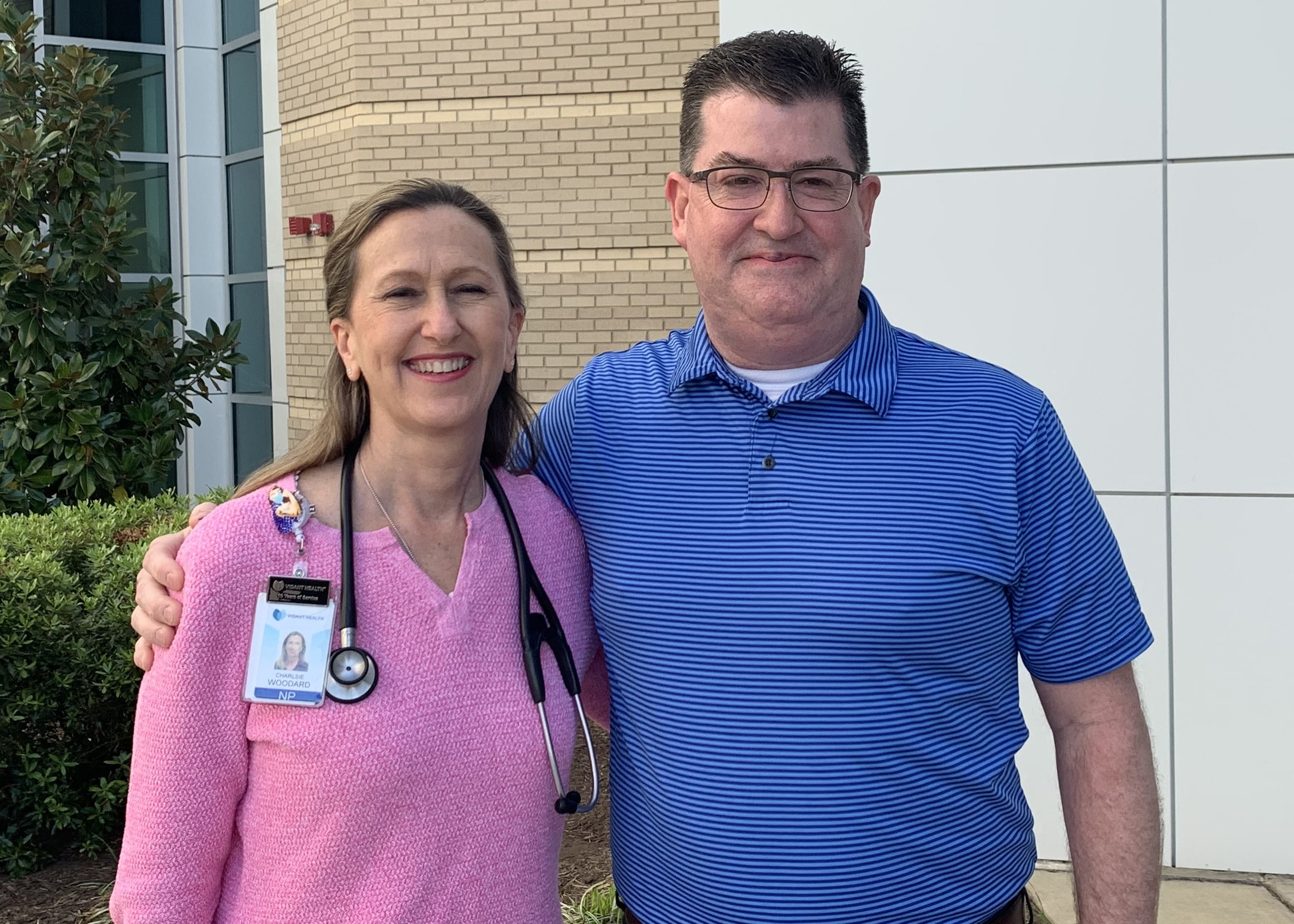 Charlsie Woodard, a nurse practitioner and hospitalist at the East Carolina Heart Institute at ECU Health Medical Center, stands with Tracy Glover, a COVID-19 survivor.