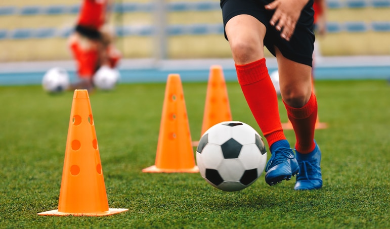 Youth soccer player dribbles