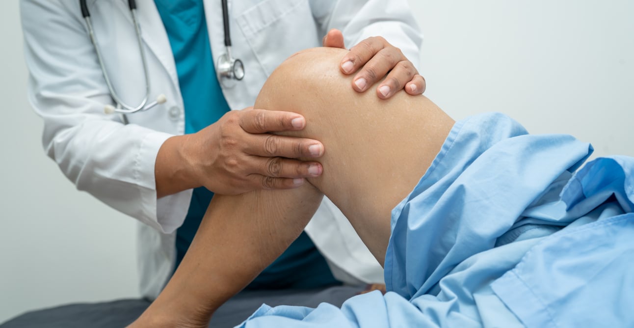robotic-technology A physician looks at surgery patient's knee.