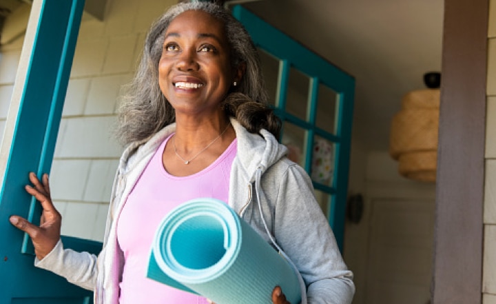 A woman gets ready for a yoga class.