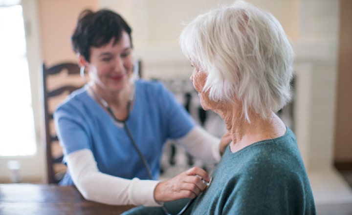 A provider listens to the heart and lungs of a patient.