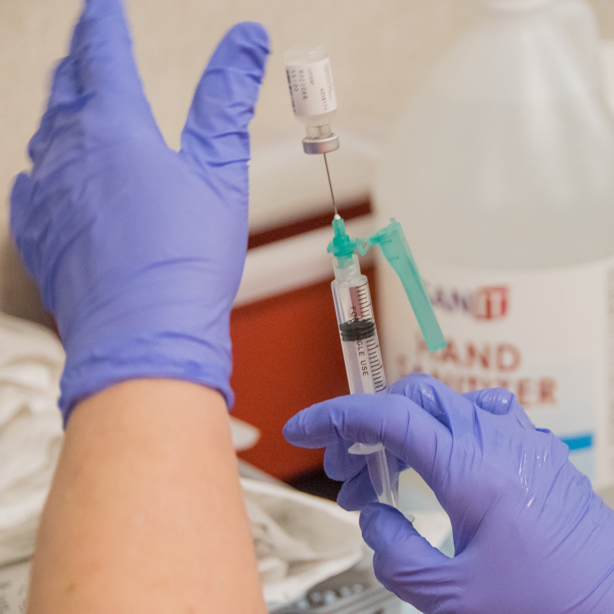 An ECU Health team member prepares a COVID-19 vaccine dose.
