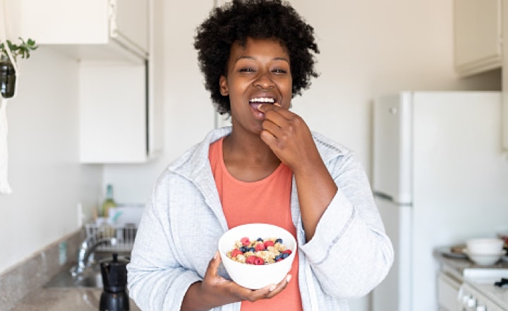A woman eats a balanced breakfast.