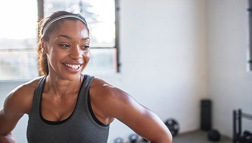 A woman finishes a workout.