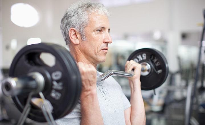 A man lifts weights at a Wellness Center.