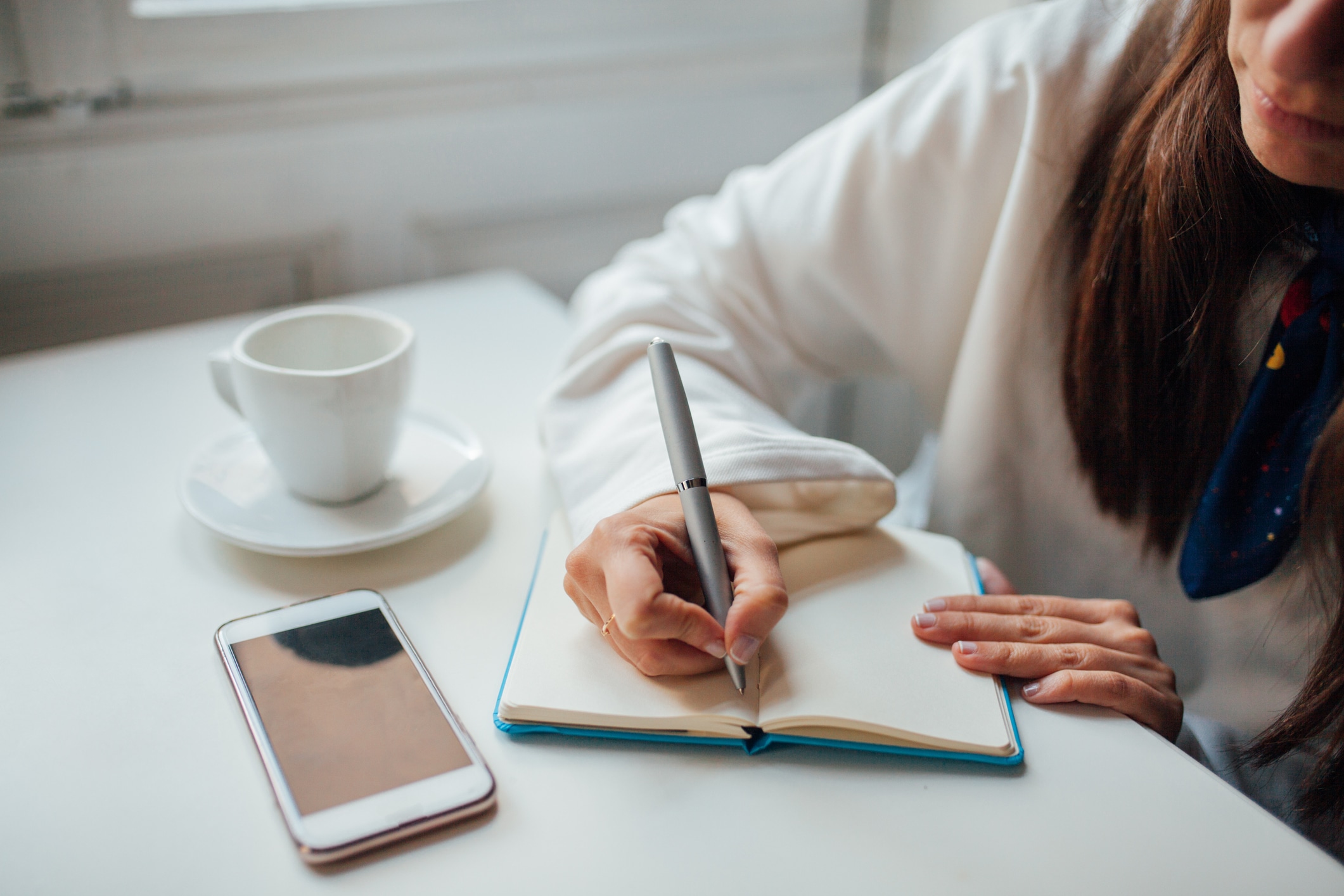 A woman makes notes in a journal.