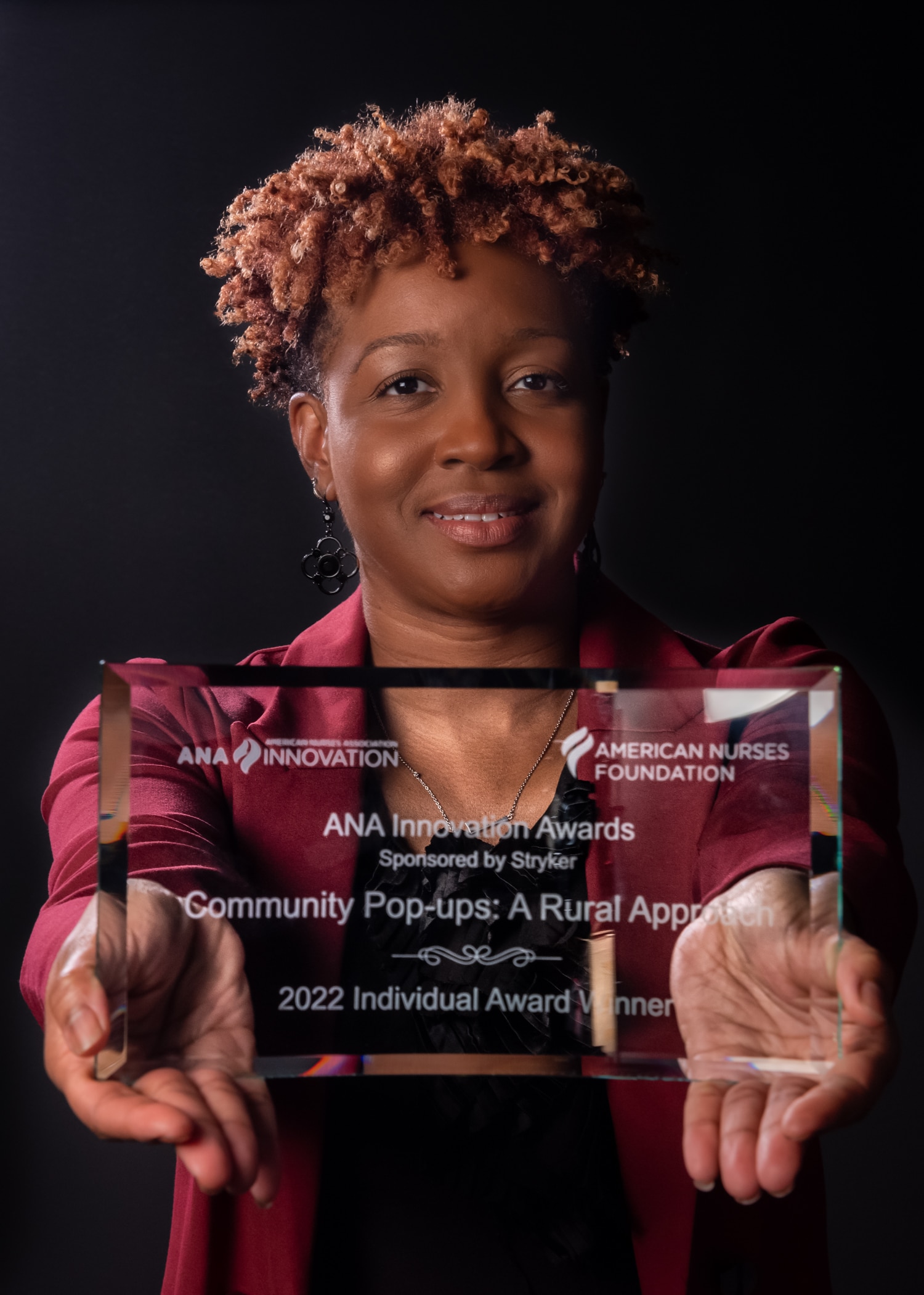 Dr. KaSheta Jackson poses with the 2022 Individual Award for the ANA Innovation Awards.