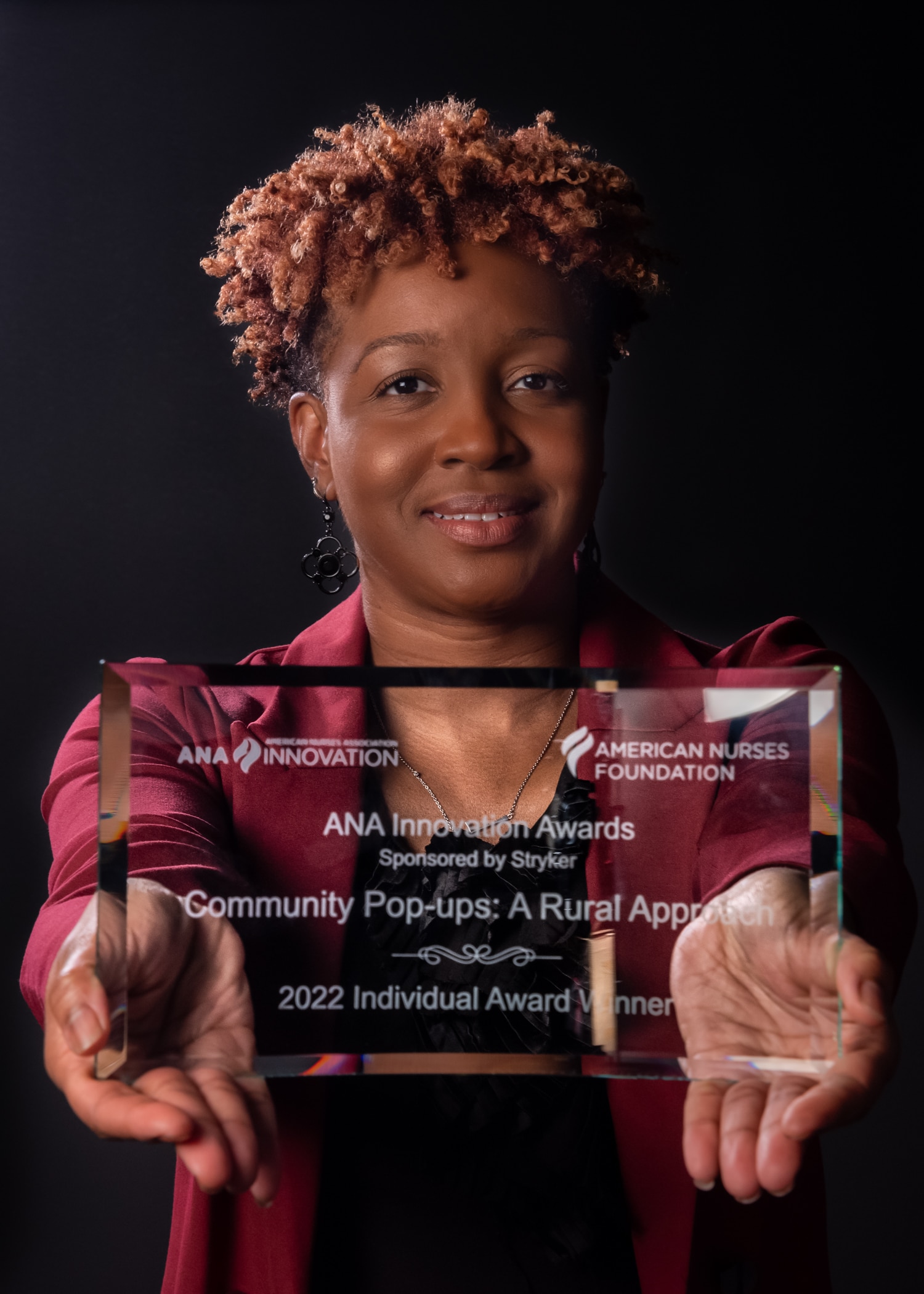 Kasheta Jackson Award_1691- Dr. KaSheta Jackson poses with the 2022 Individual Award for the ANA Innovation Awards.