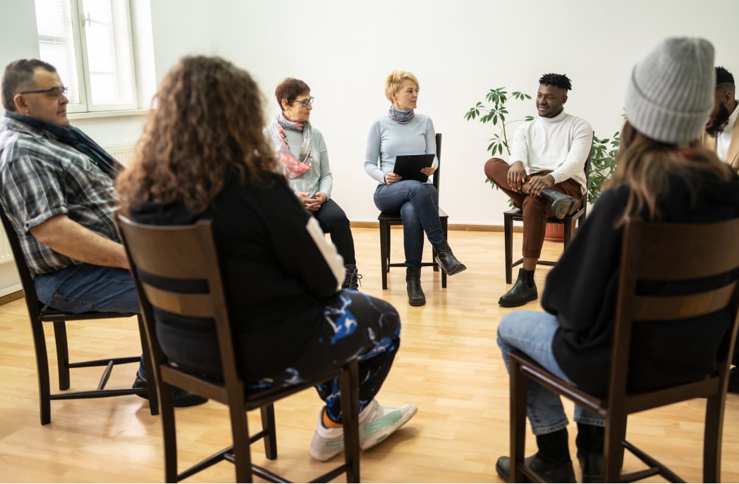 GettyImages-1308950633 A support group meets to discuss.