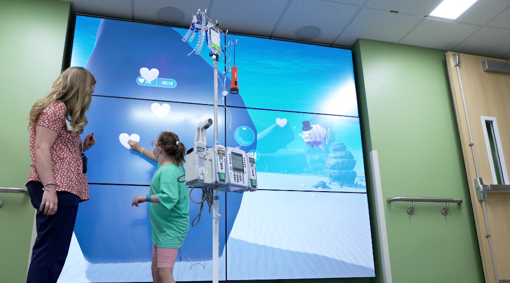 A pediatric patient plays on the interactive wall at the Maynard Children's Hospital at ECU Health Medical Center.