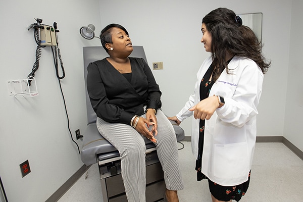 A provider talks to a patient about clinical trials