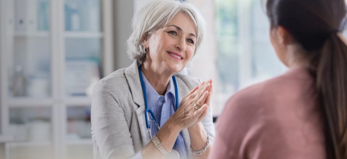 A health care provider speaks with a patient.