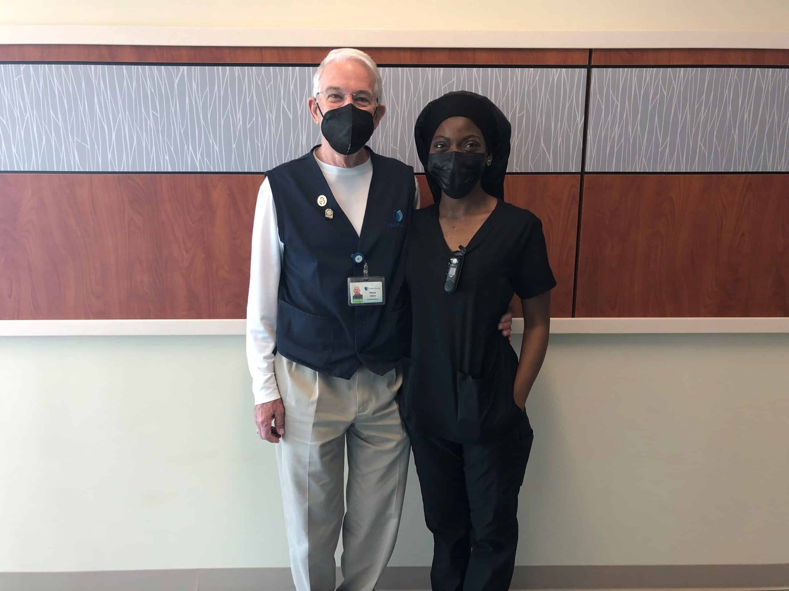 Volunteer-and-Nurse-Photo-scaled Volunteer Frank Crawley poses for a photo with ECU Health Medical Center nurse Felicia Parker