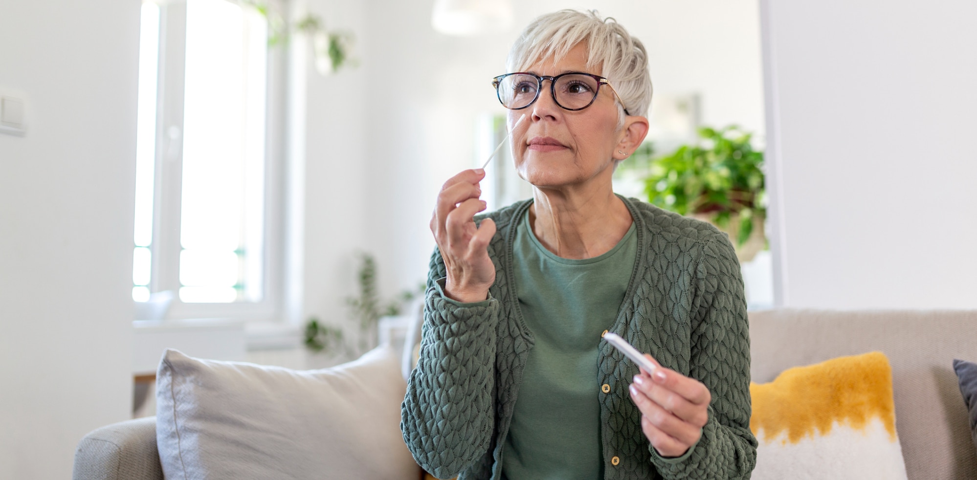 A woman takes a COVID-19 home test.