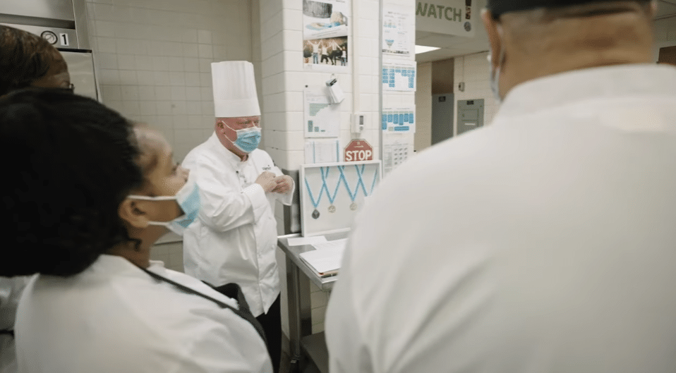 ECU Health team members listen during a safety huddle in the kitchen of ECU Health Beaufort Hospital, a campus of ECU Health Medical Center.