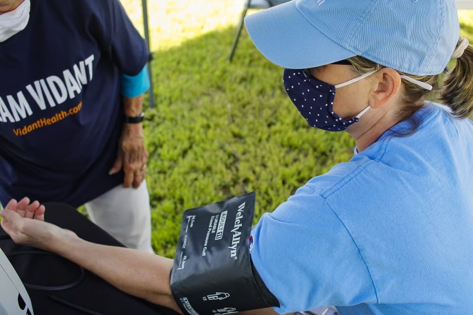 A community member has their blood pressure checked during a Community Pop-up event.