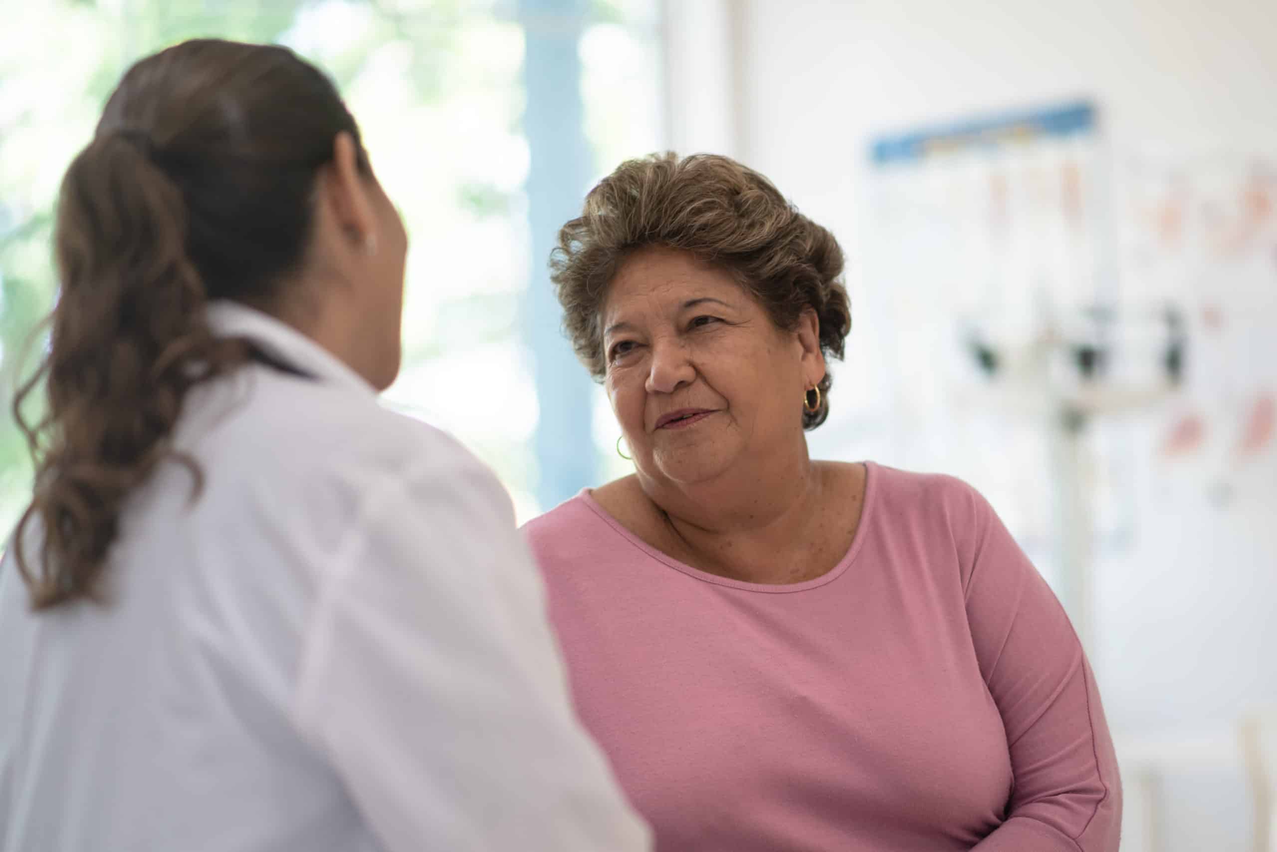 Older Woman talking with the Doctor stock photo