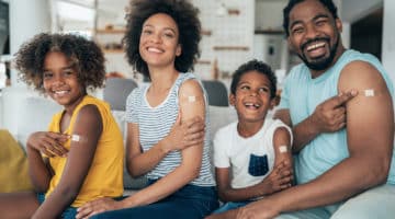 A family poses for a photo after receiving a COVID-19 vaccine.