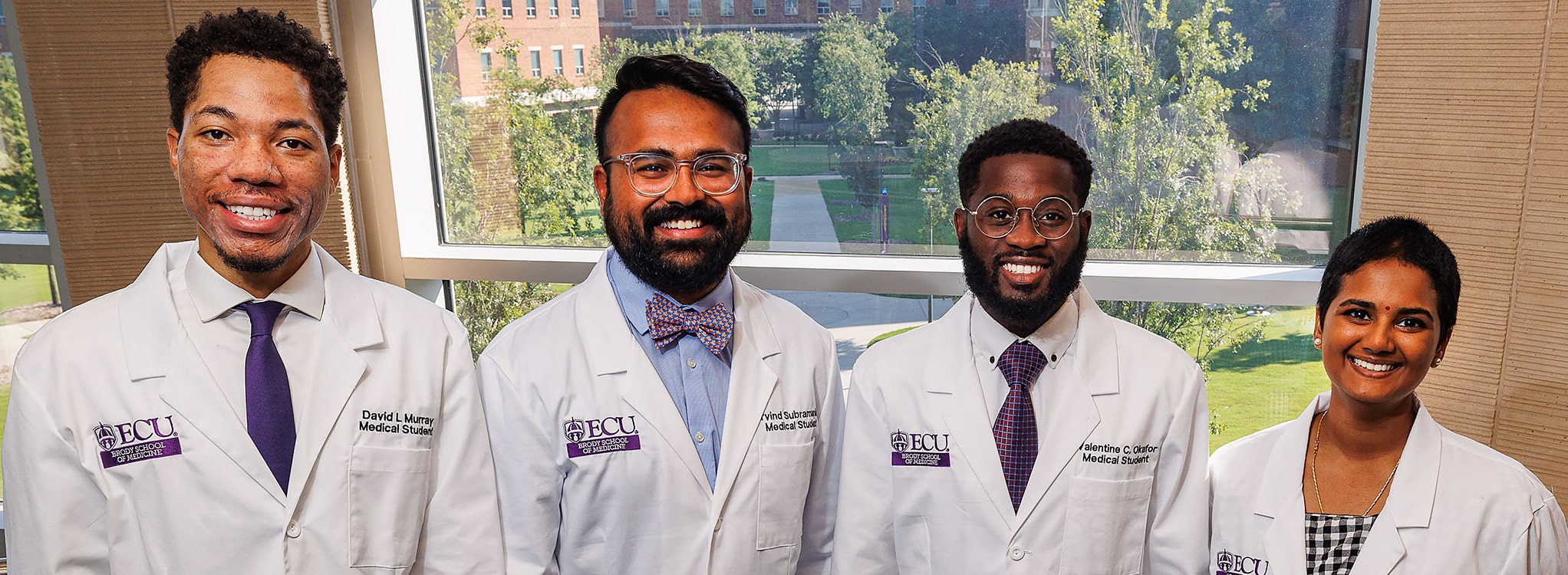 Four Brody Scholar Award winners pose for a photo in the Brody School of Medicine.