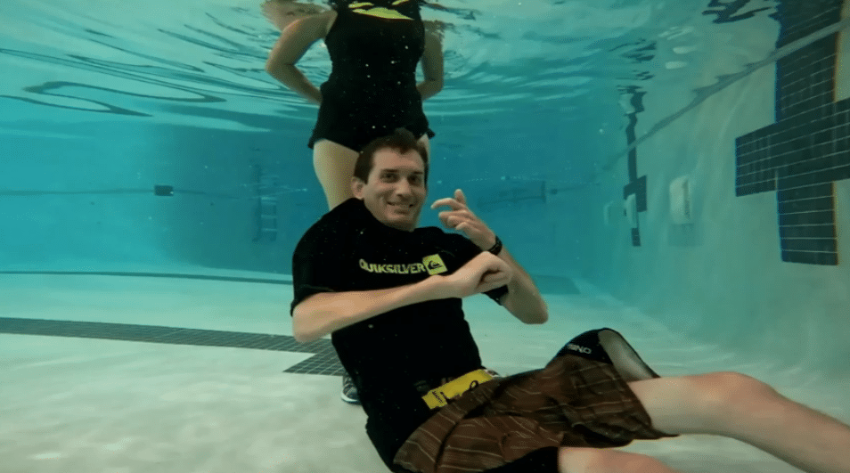 Paralyzed from a diving accident, Brent Carpenter gives the camera a thumbs up while underwater during a training session for a swim across Lake Gaston.