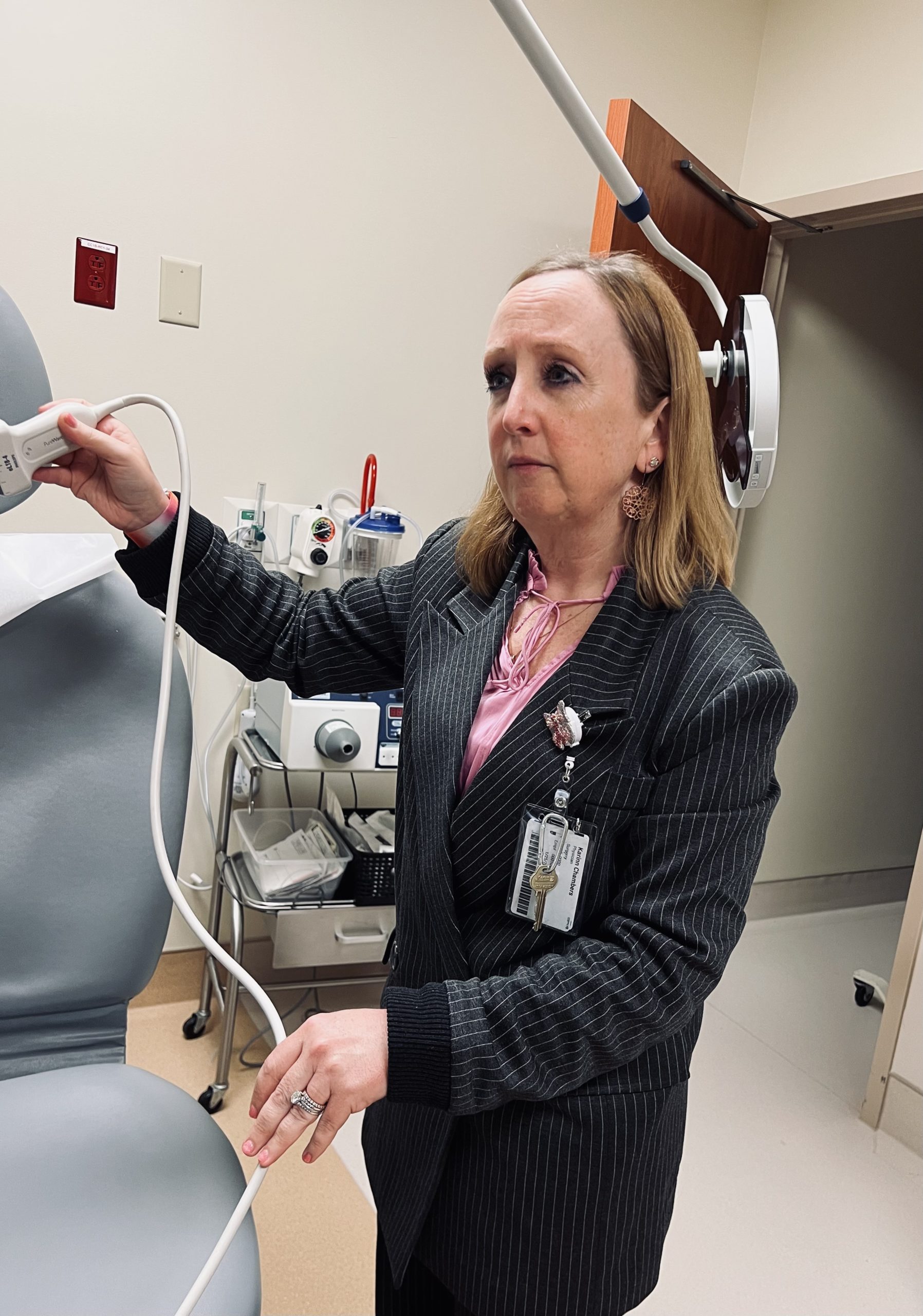 Dr. Karinn Chambers models a technology for a breast cancer screening.