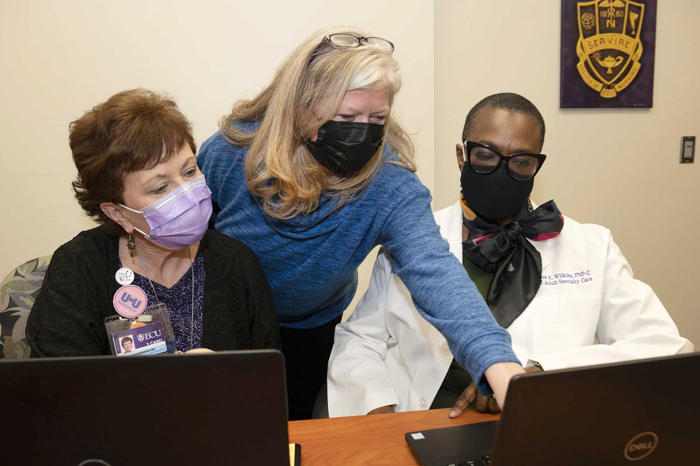 Dr. Courtney Cailola, center, works with Donna Roberson, left, faculty in the ECU College of Nursing and Grace Wilkins from the ECU Adult Specialty Care Clinic.