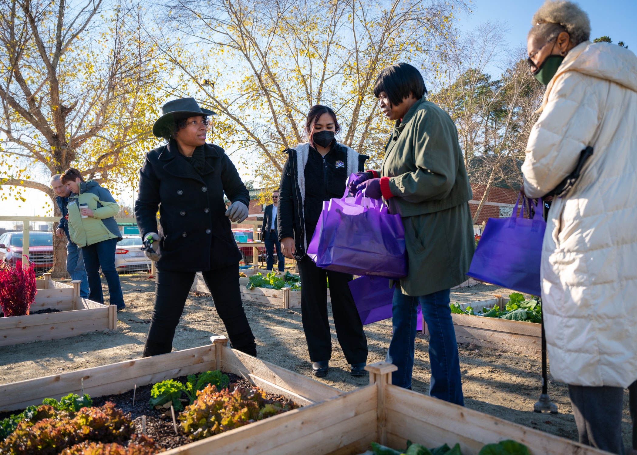 An ECU Health leader prepares to help harvest fresh produce for community members at the Beaufort Community Garden outside of the ECU Health Wellness Center - Washington.