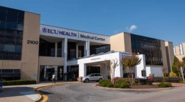 The main entrance of ECU Health Medical Center in Greenville is shown on a sunny day.