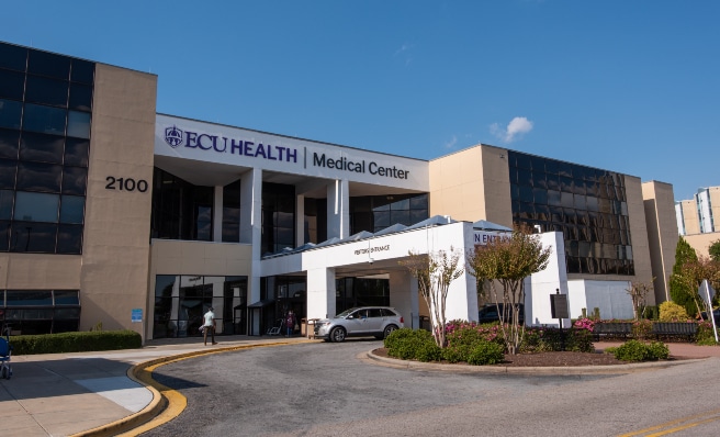 ECUH Med Ctr EXT - Main Entrance-2937-Edit The main entrance of ECU Health Medical Center in Greenville is shown on a sunny day.