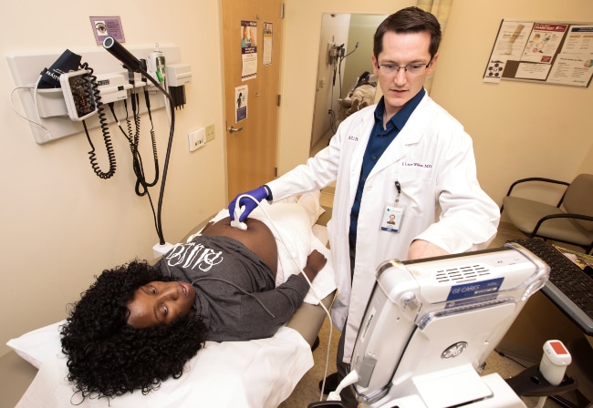 A provider gives a pregnant mother an ultrasound at an ECU Health clinic.