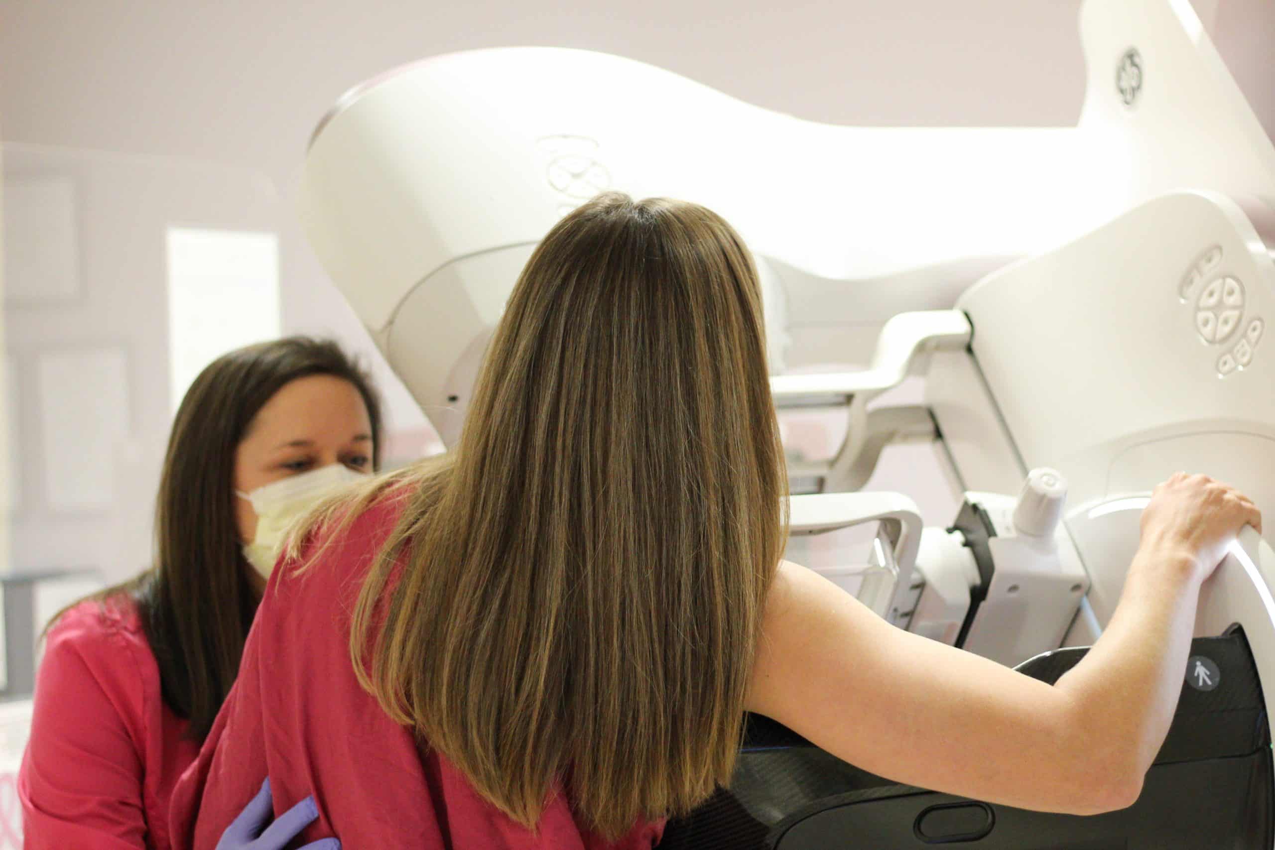 An ECU Health team member assists a patient during a mammogram.