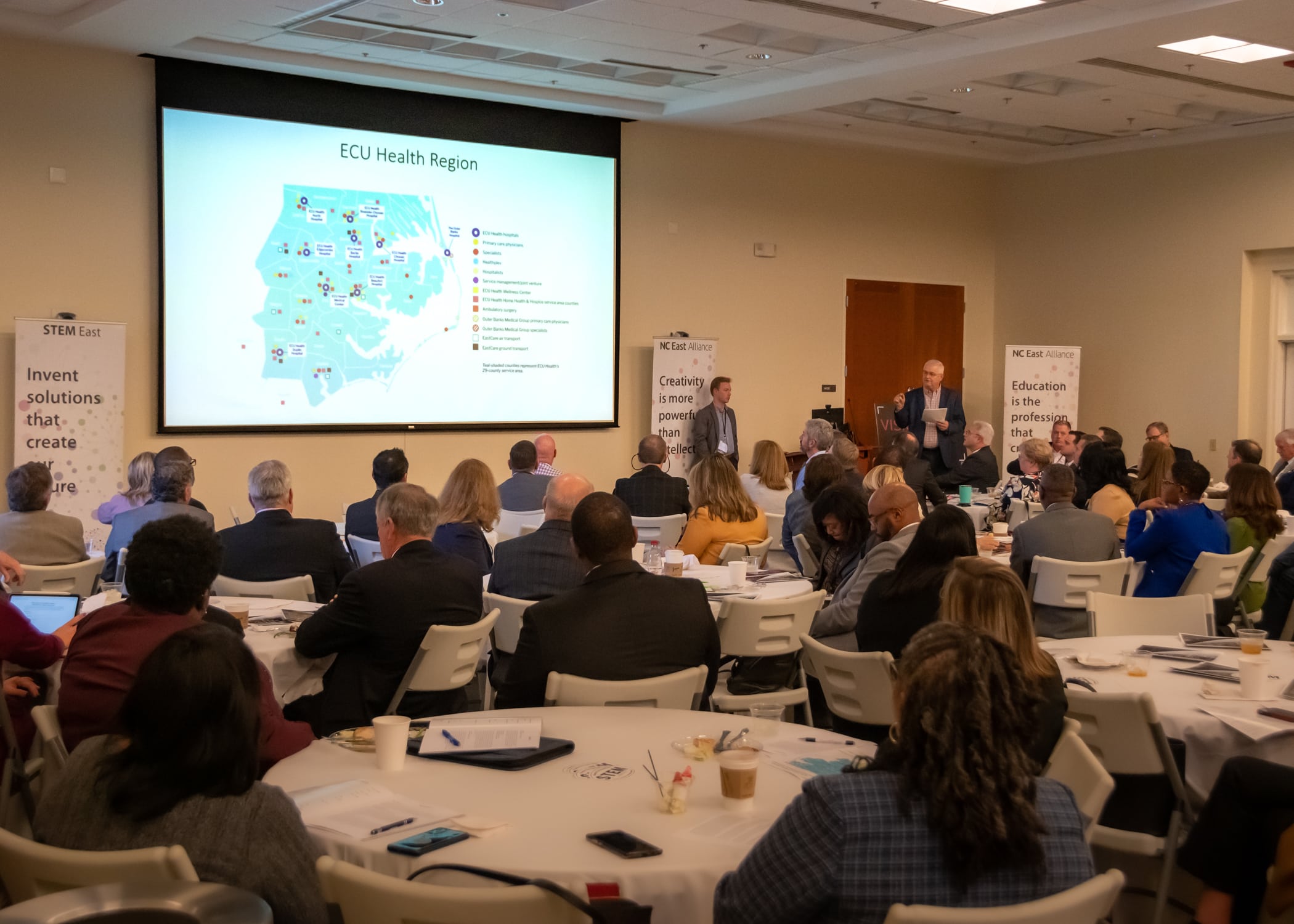 Attendees listen to a presenter during the Vision 2023 event hosted by NC East Alliance.